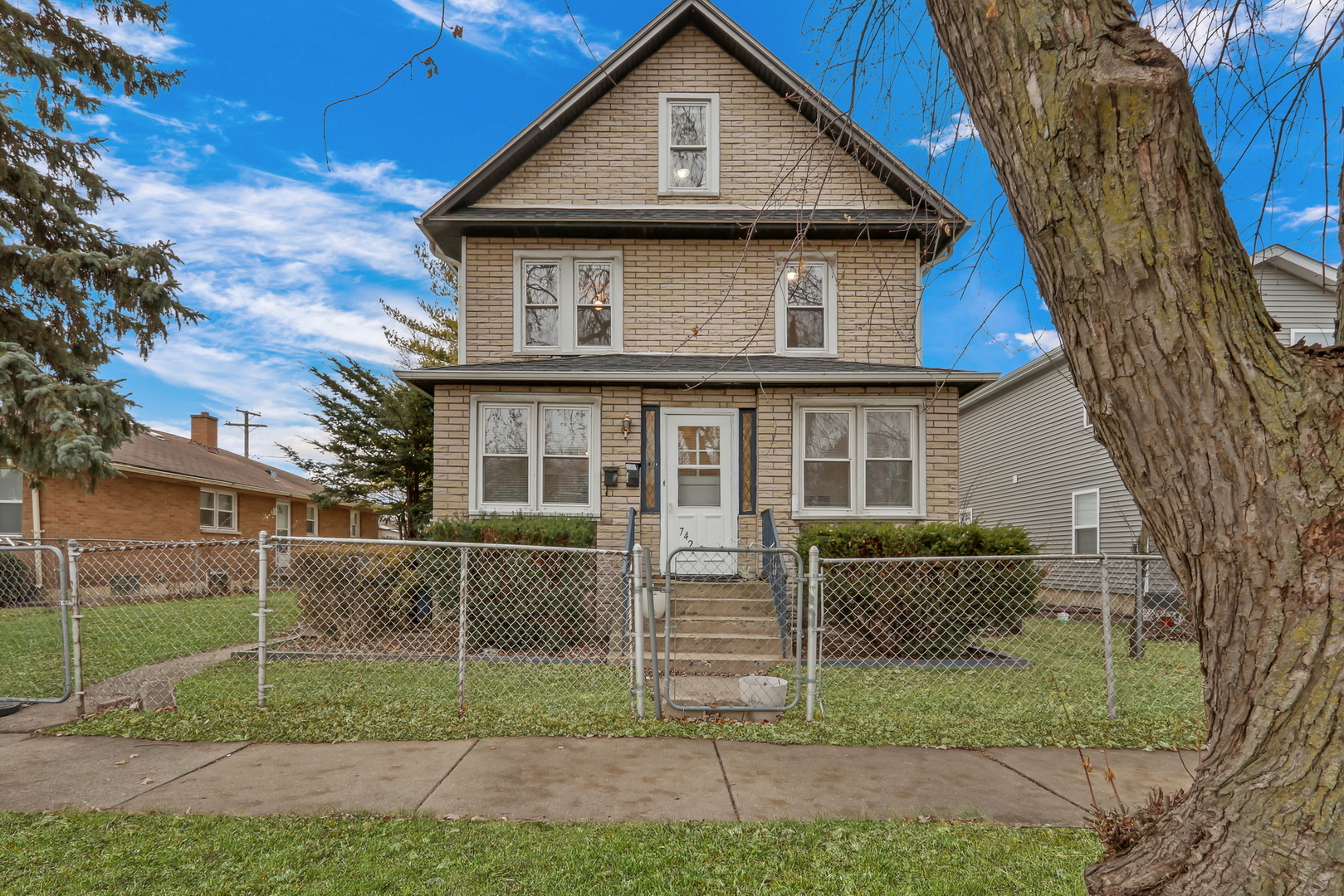 a front view of a house with a garden