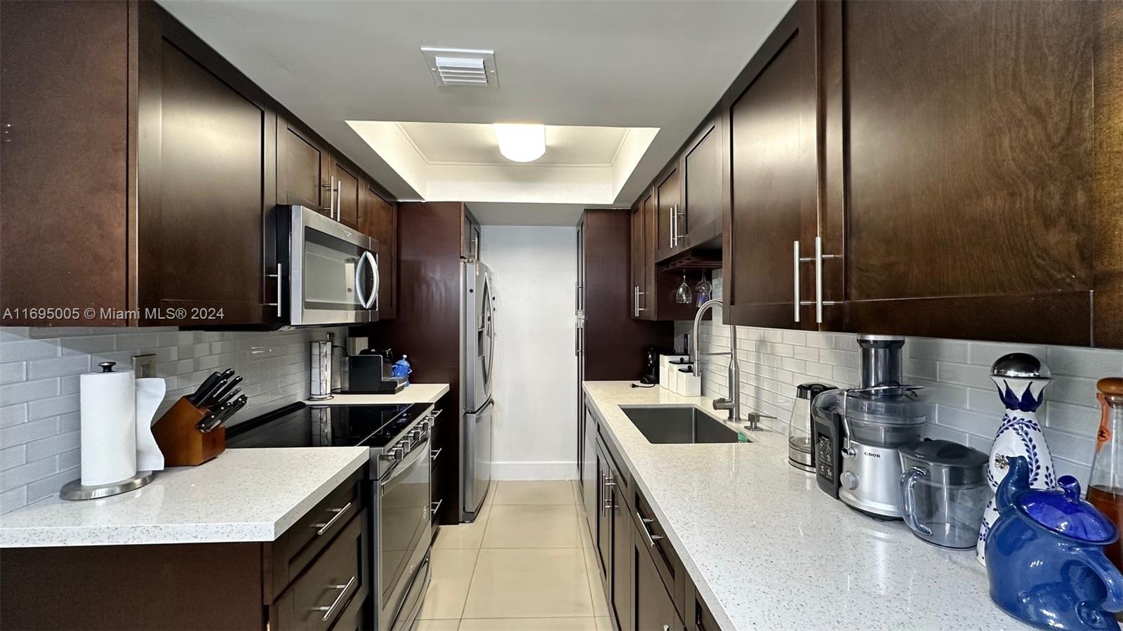 a kitchen with refrigerator and sink