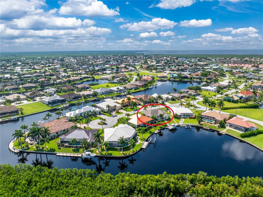 an aerial view of residential houses with outdoor space and swimming pool