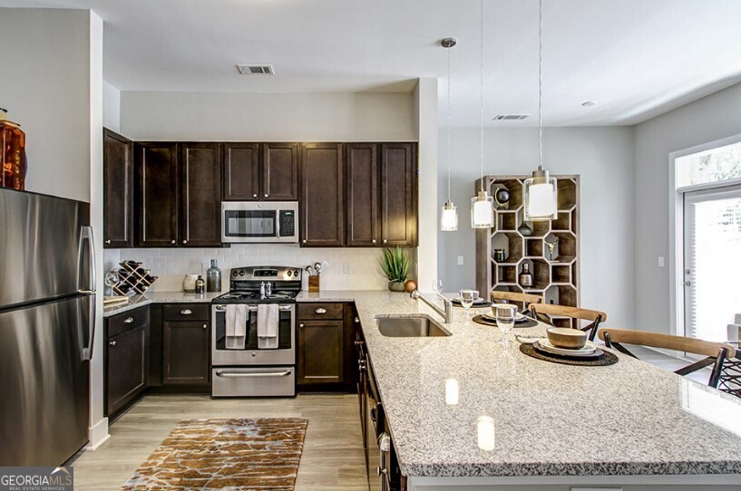 a kitchen with a refrigerator sink and stove