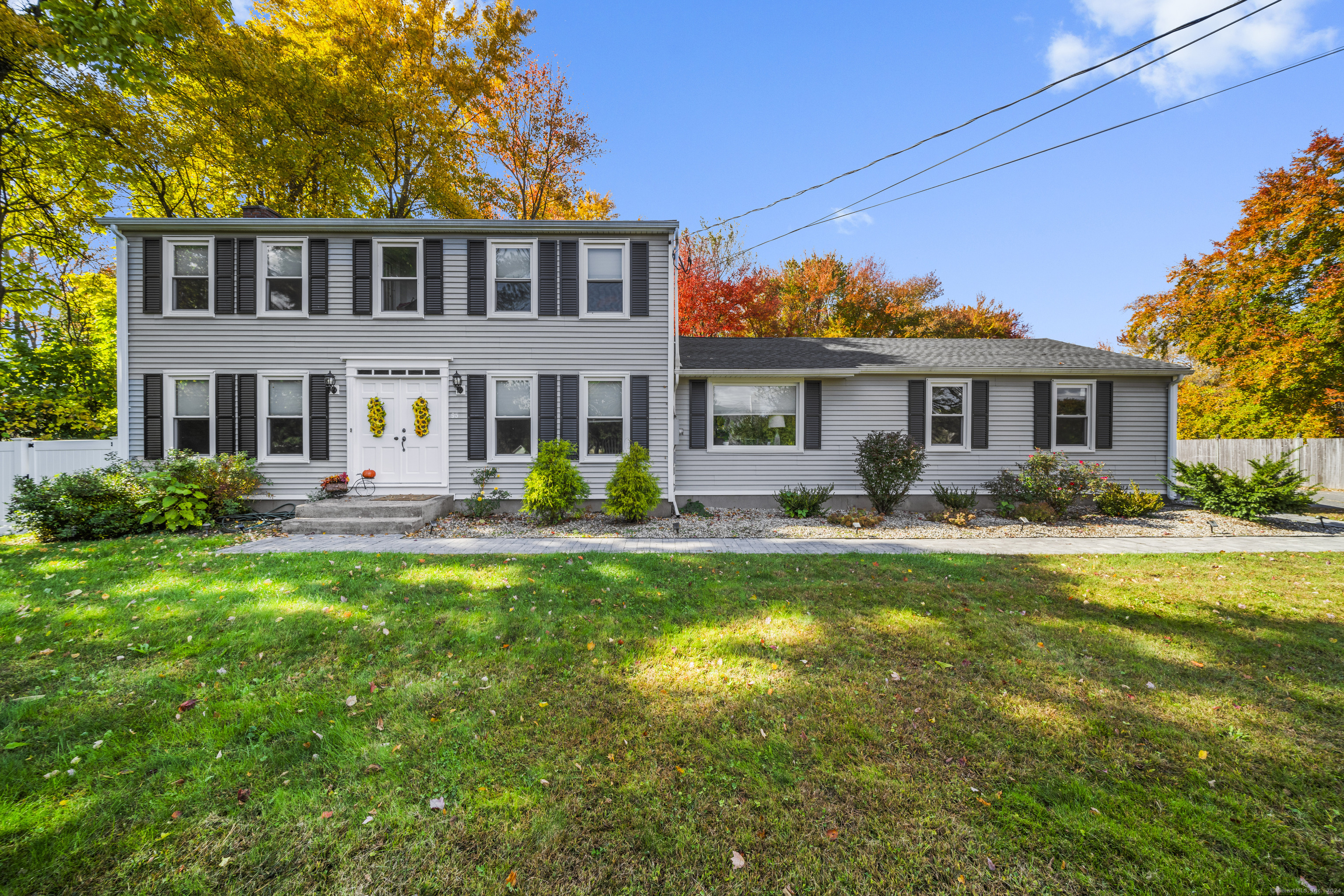 a front view of a house with yard and green space