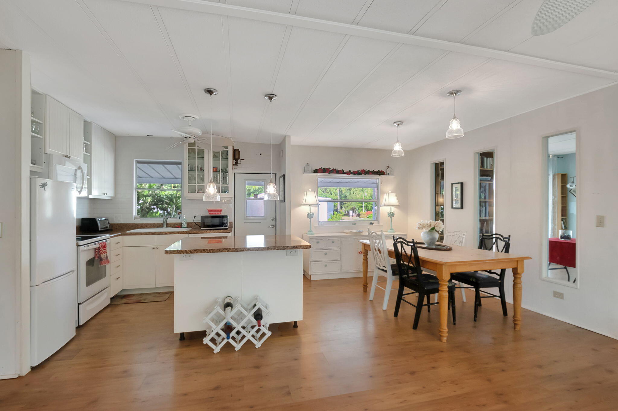 a view of a dining room with furniture and chandelier