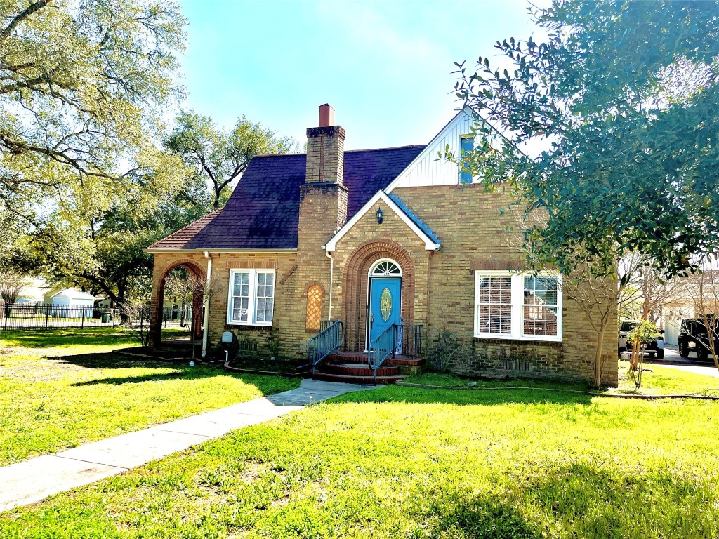 a front view of house with yard and green space