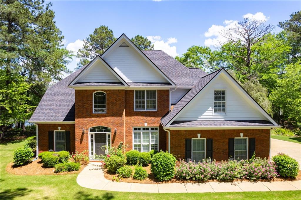 a house that has a tree in front of it