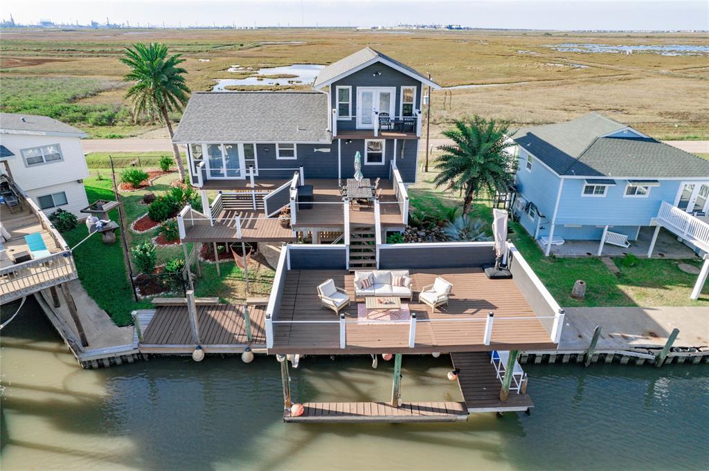 an aerial view of a house with outdoor seating