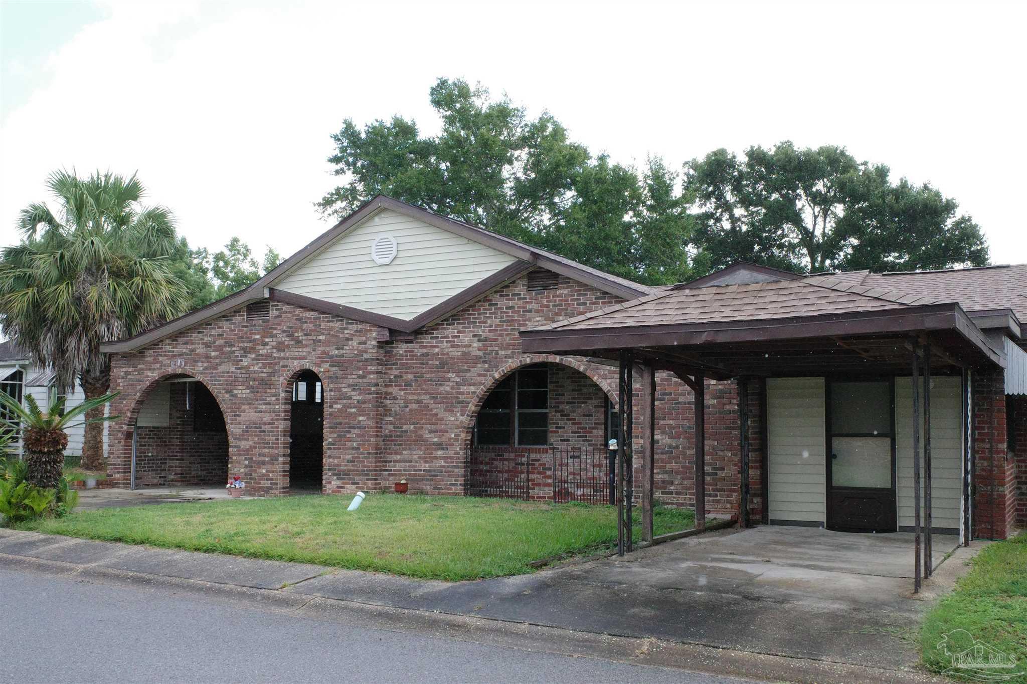 a front view of a house with a garden and garage