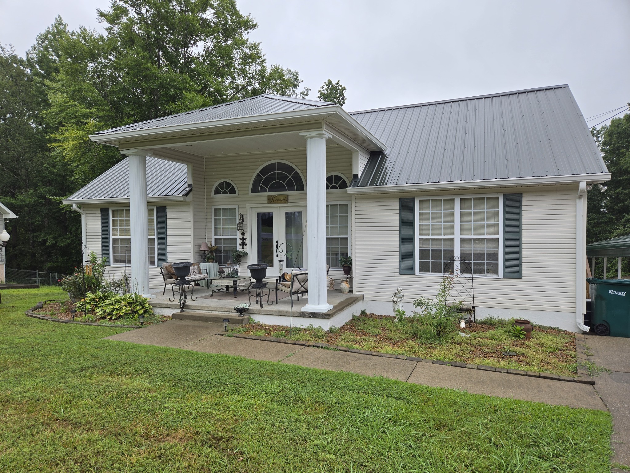 a front view of a house with garden and porch