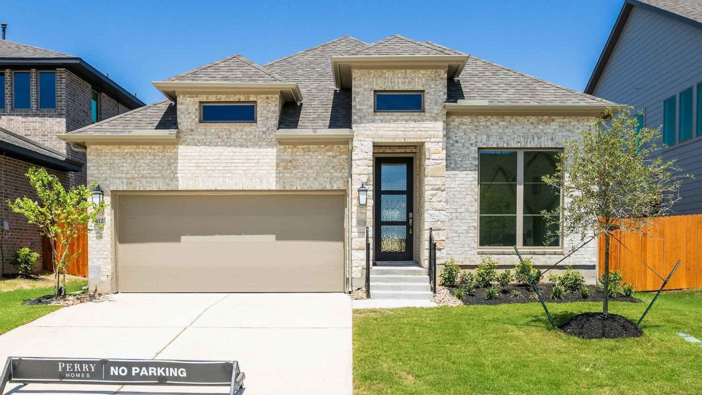 a front view of a house with a yard