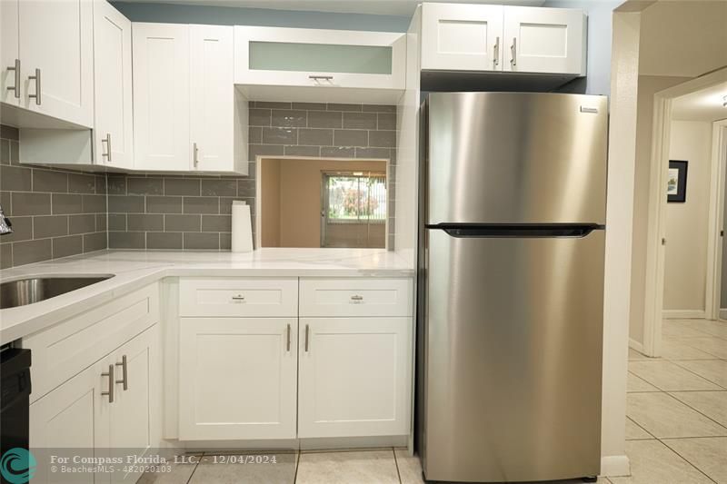 a white refrigerator freezer sitting inside of a kitchen