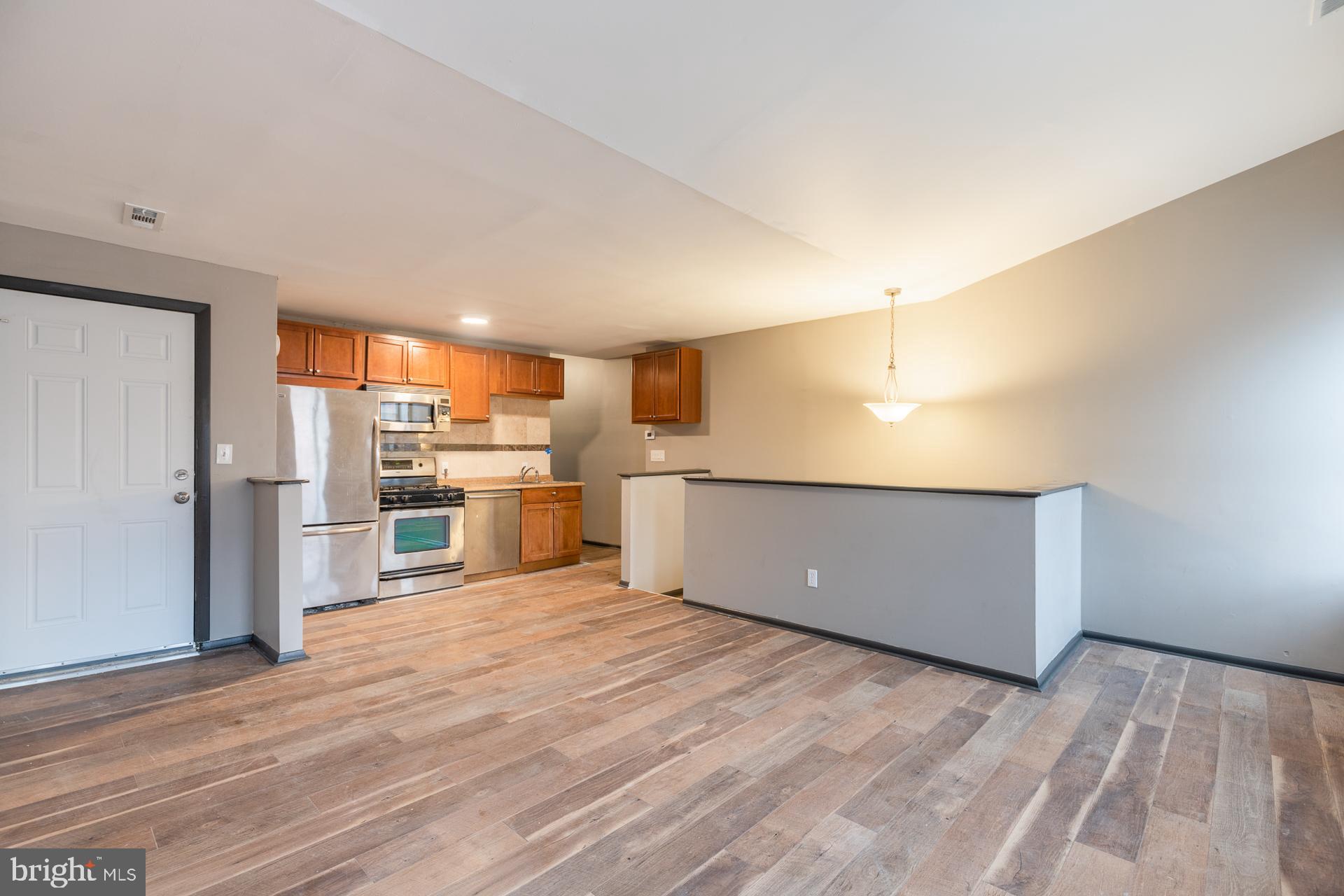 a view of a kitchen with a sink and stainless steel appliances