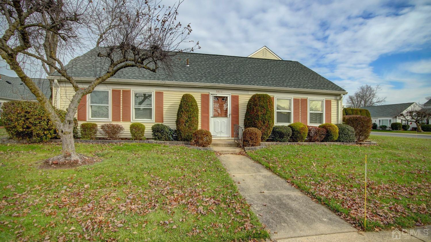 a front view of house with yard and green space