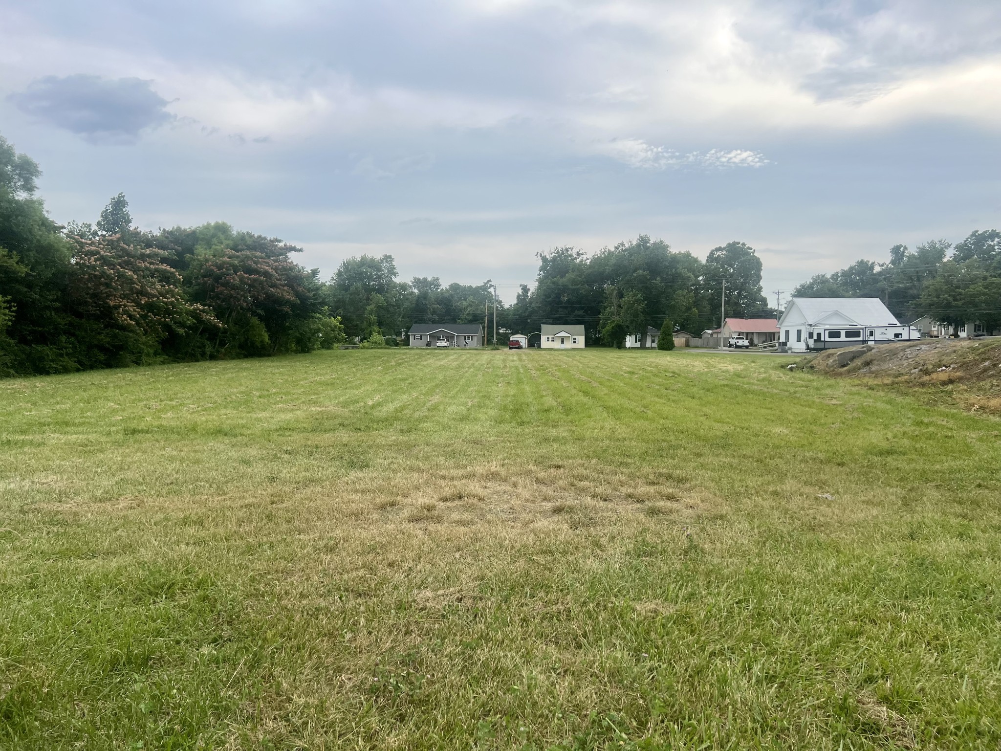 a view of field with trees in the background