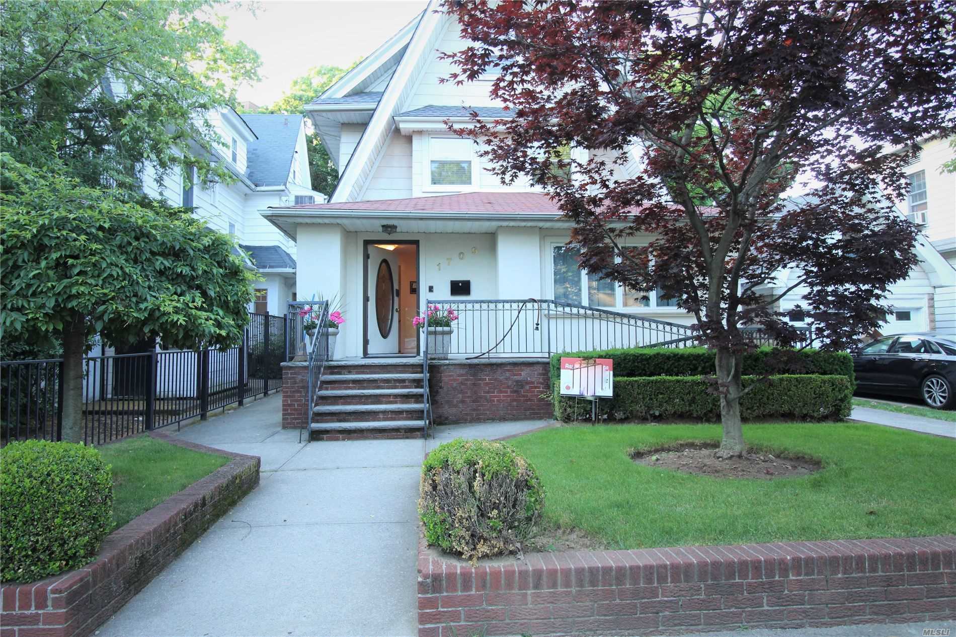 a front view of a house with garden