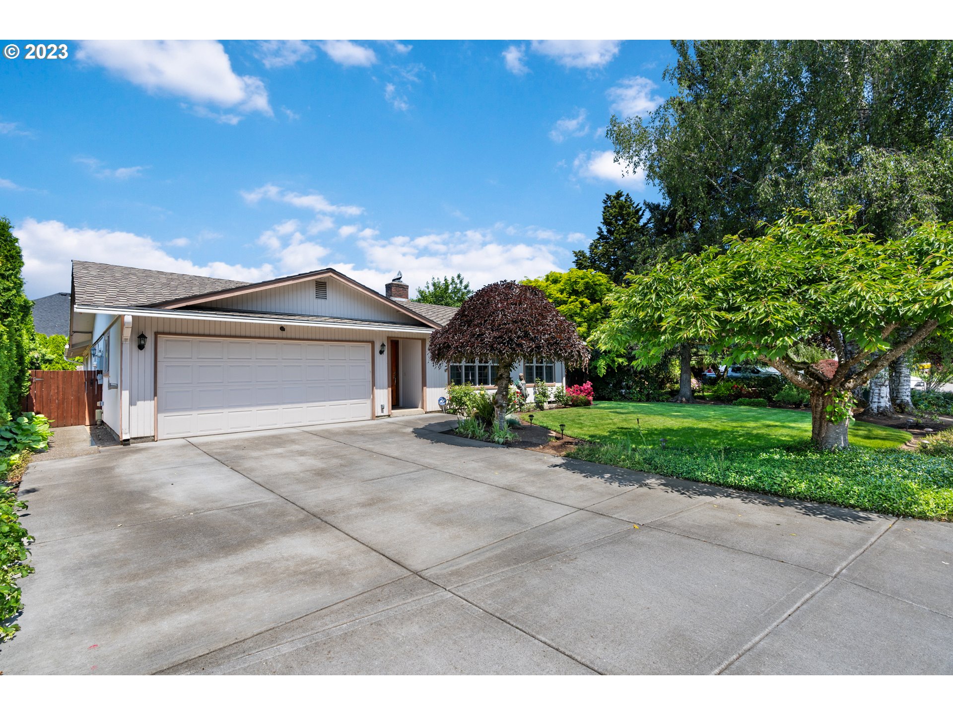 a view of a house with a yard and garage