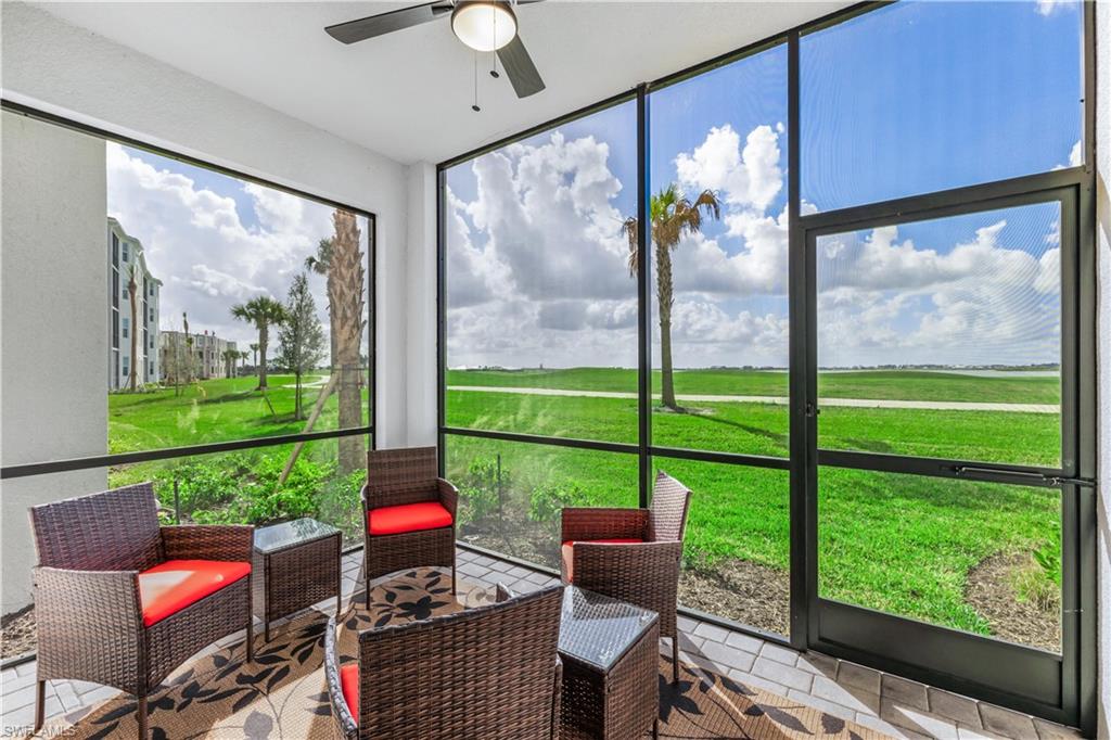 a living room filled with furniture and a floor to ceiling window