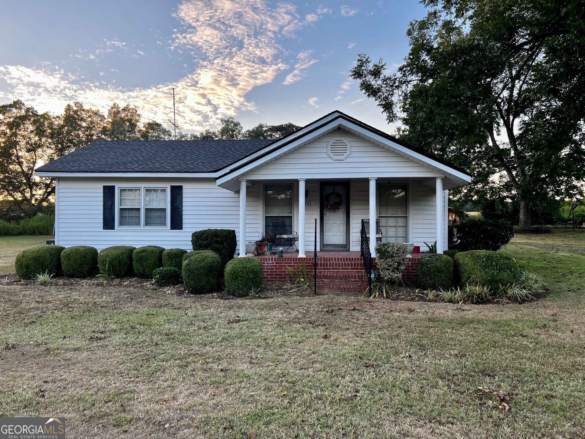 a front view of a house with garden