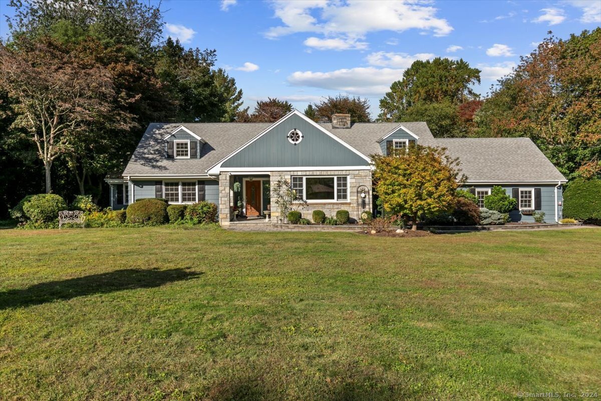 a front view of a house with a garden