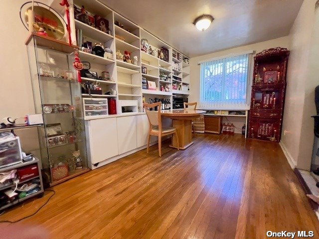 a view of a workspace with furniture and wooden floor