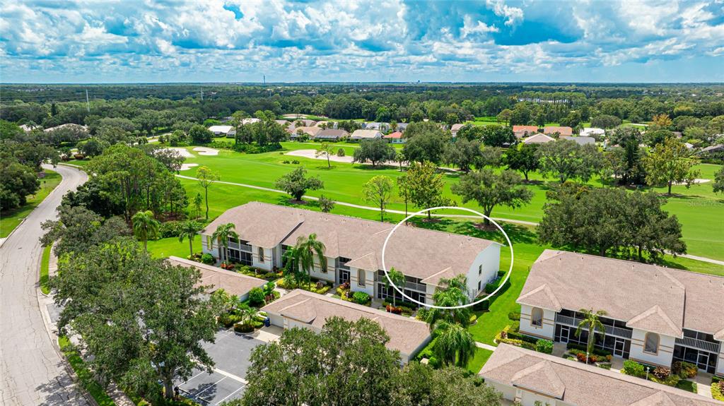 an aerial view of a house with a garden and outdoor seating