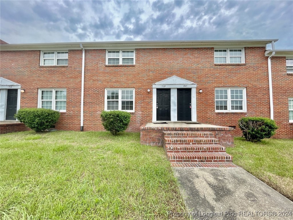 front view of a house with a yard