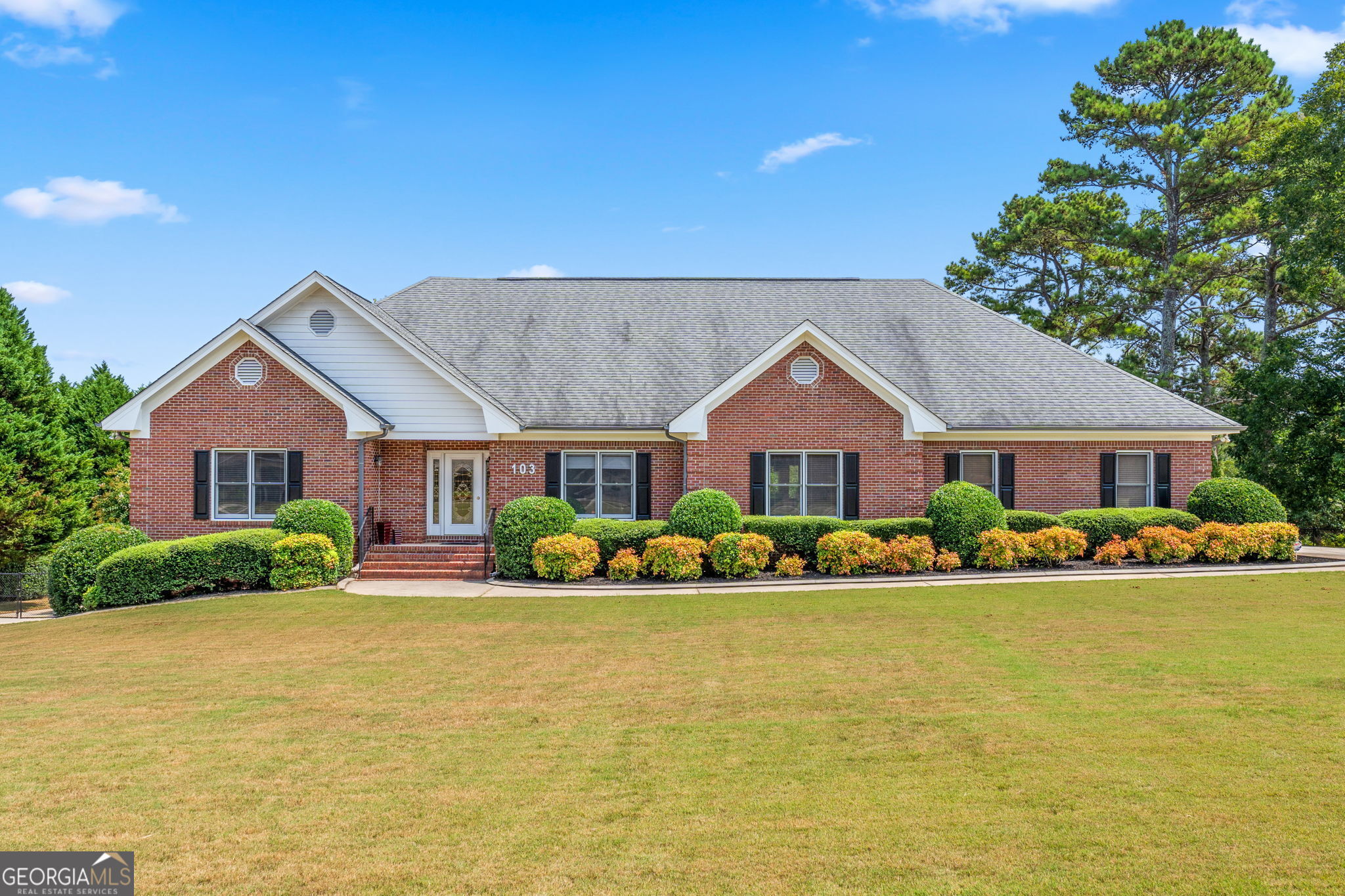 a front view of a house with a yard