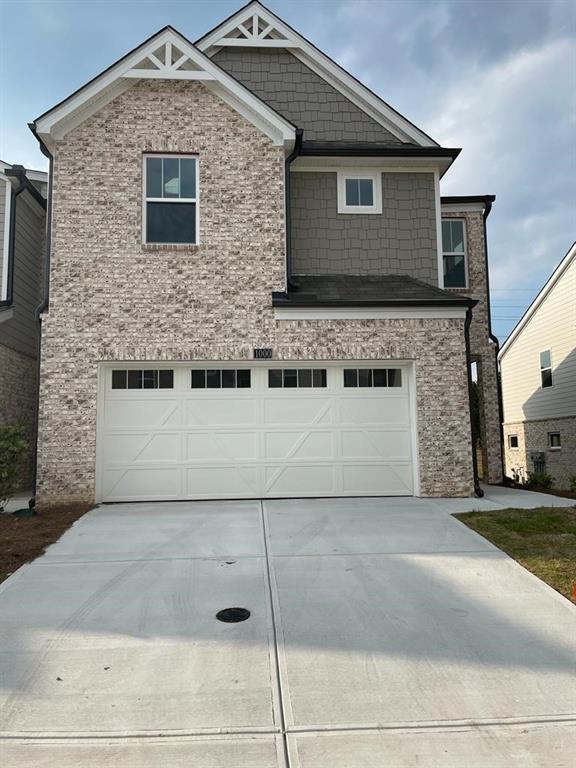 a front view of a house with garage