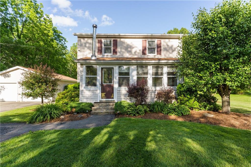 a front view of house with yard and green space