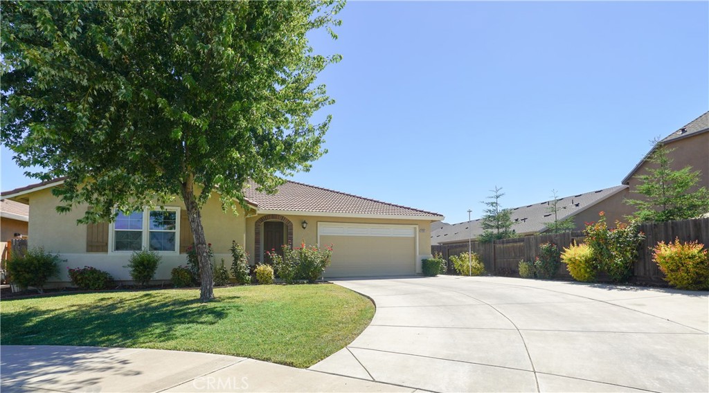 a front view of a house with a yard and a garage