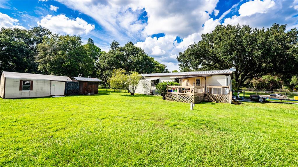 a view of house with yard and entertaining space