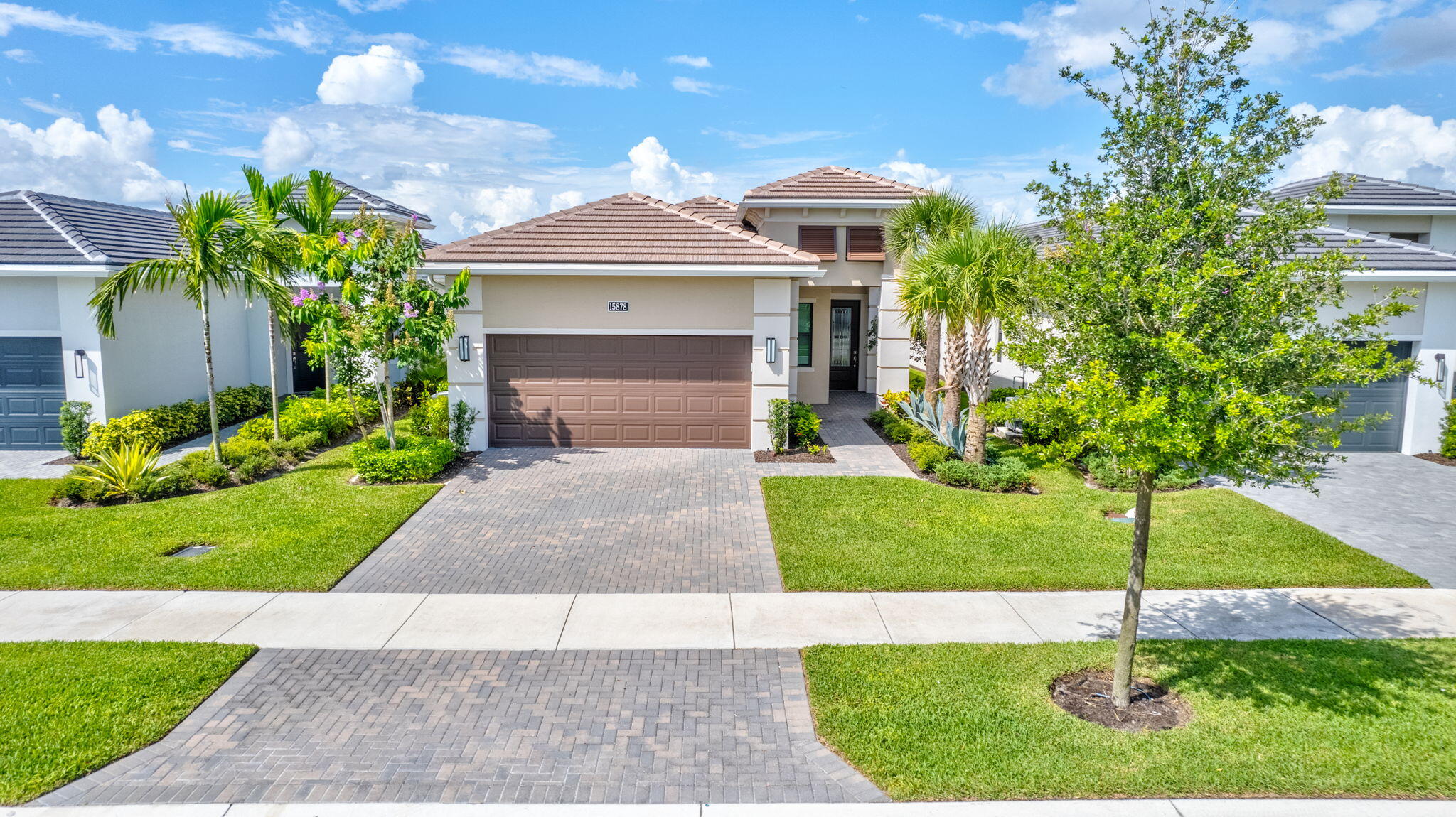 a front view of a house with a yard and garage