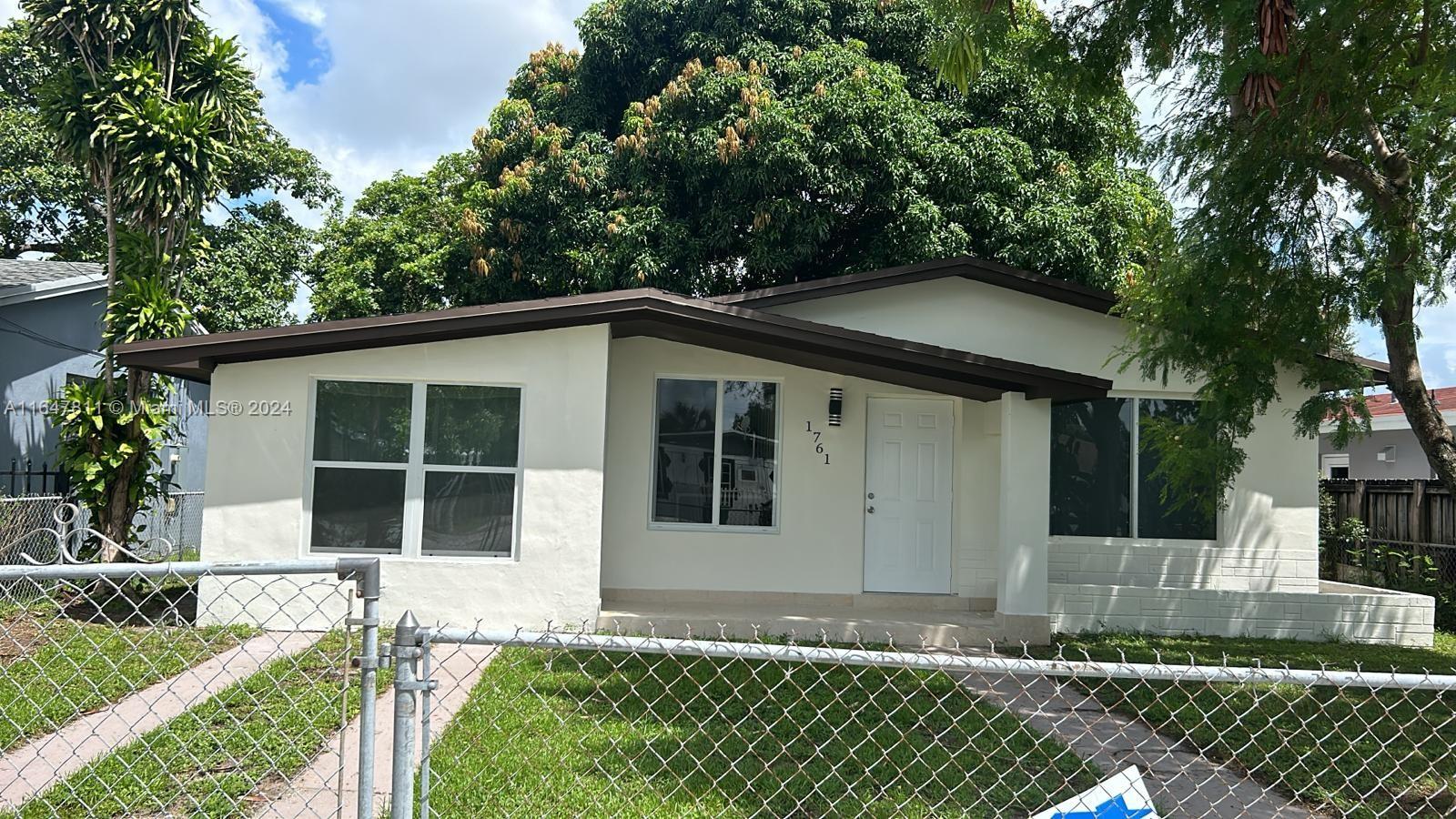 a house with trees in the background