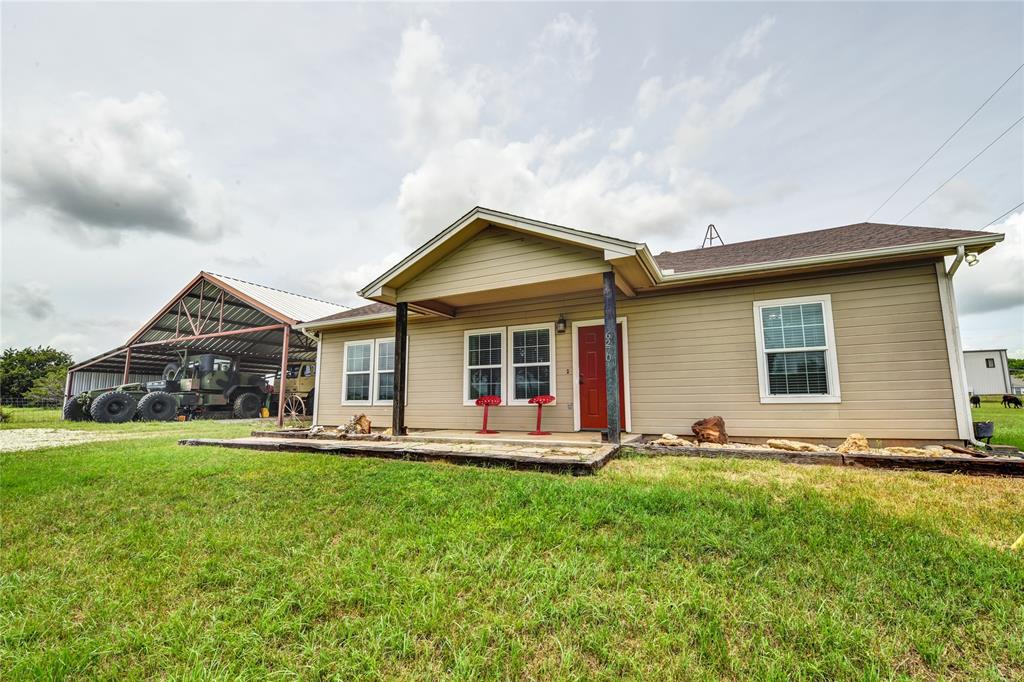 a front view of a house with a yard and porch