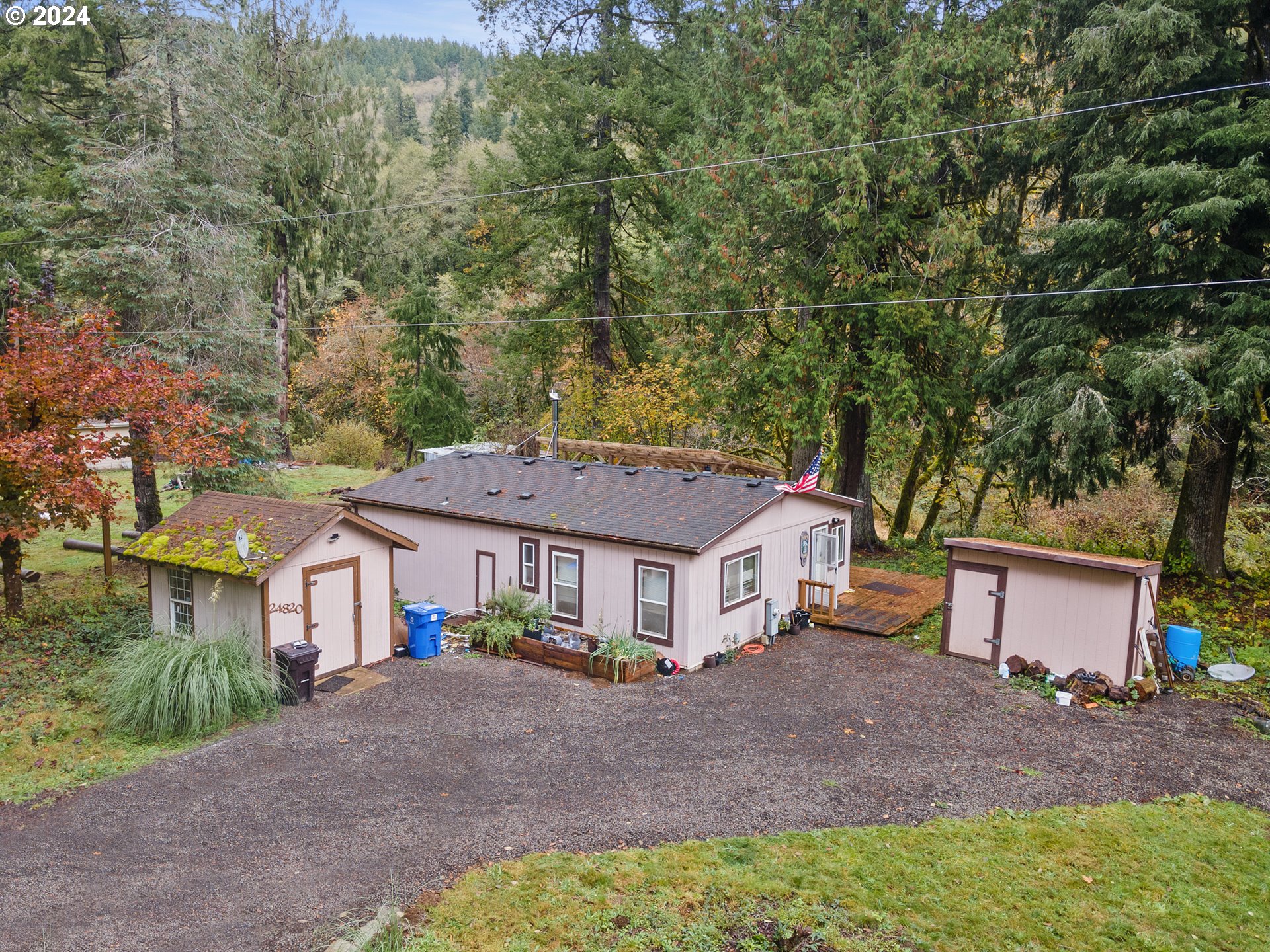 a aerial view of a house with a yard and large tree