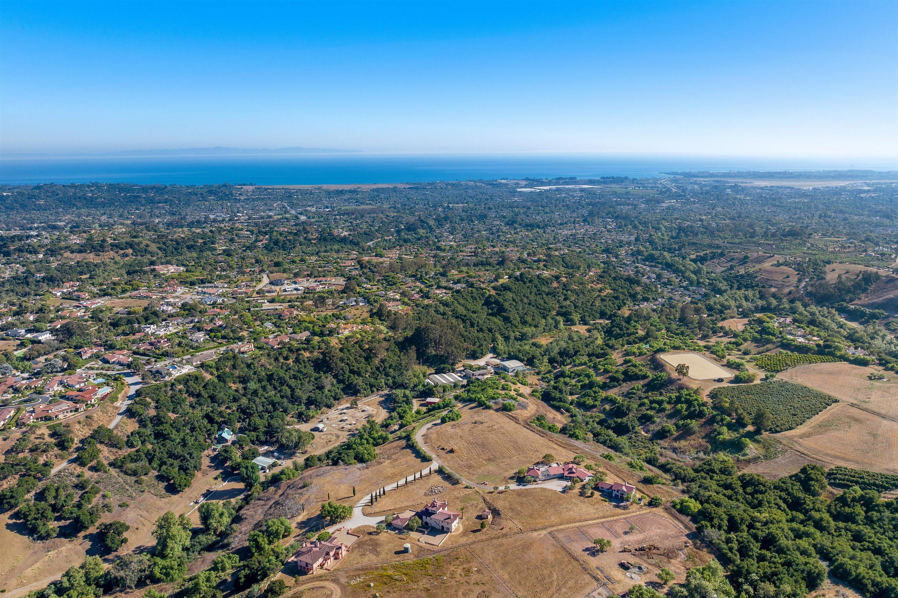 an aerial view of residential building with green space