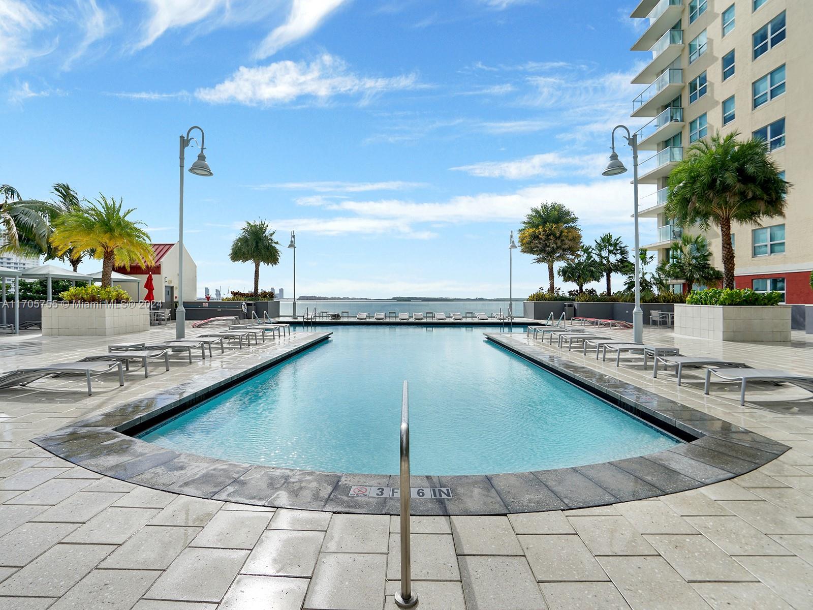 a swimming pool with outdoor seating and plants