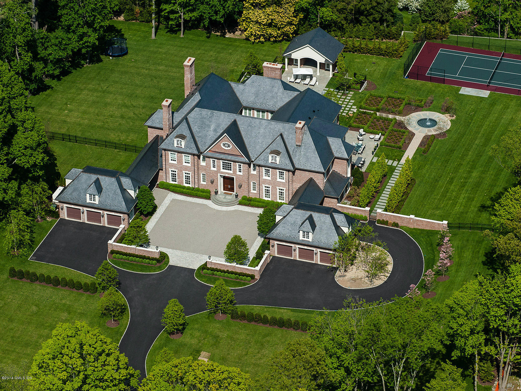 an aerial view of a house with garden space and street view