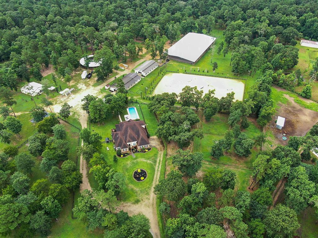 a aerial view of a house with a yard and trees