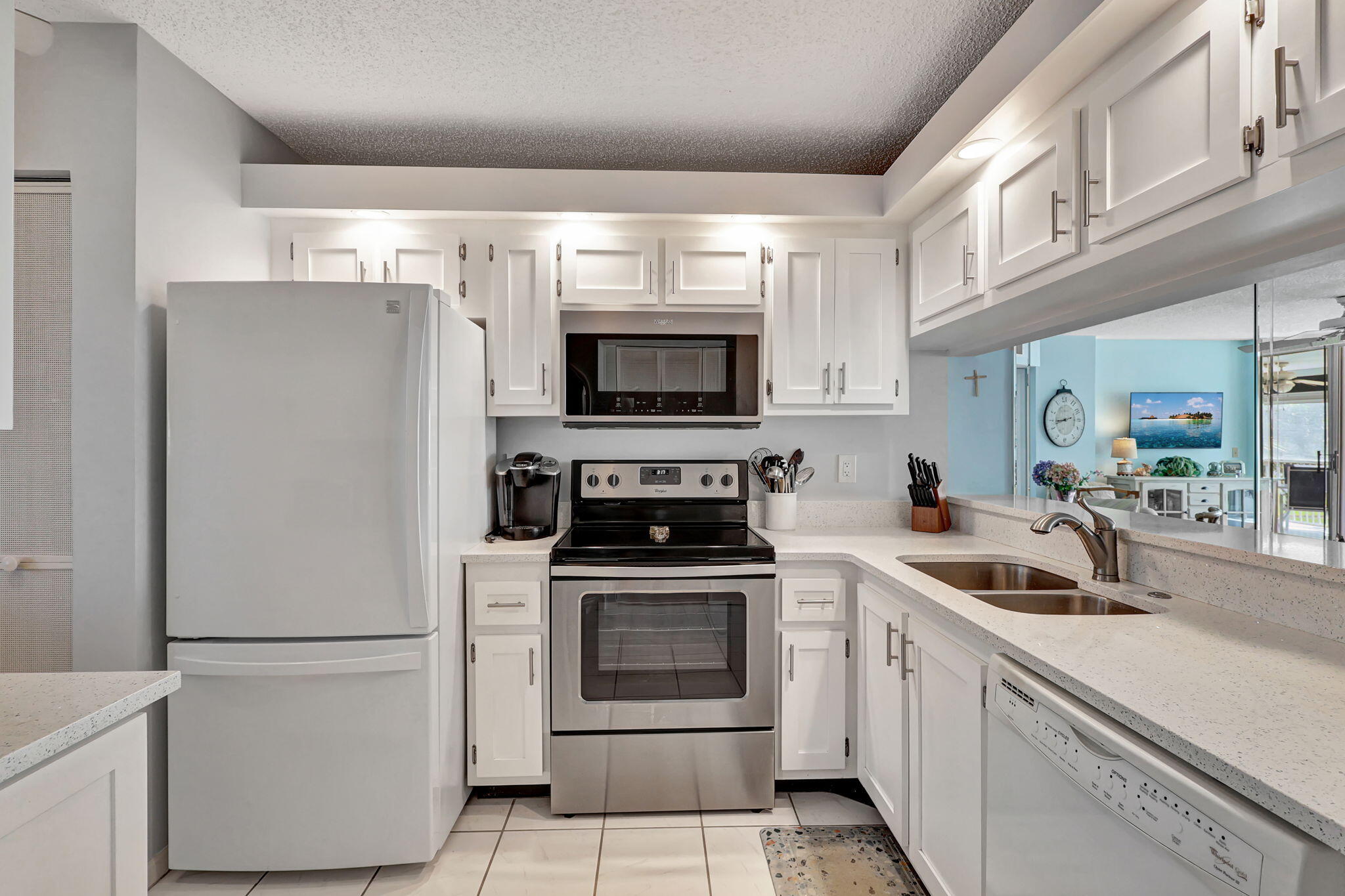 a kitchen with white cabinets and white appliances