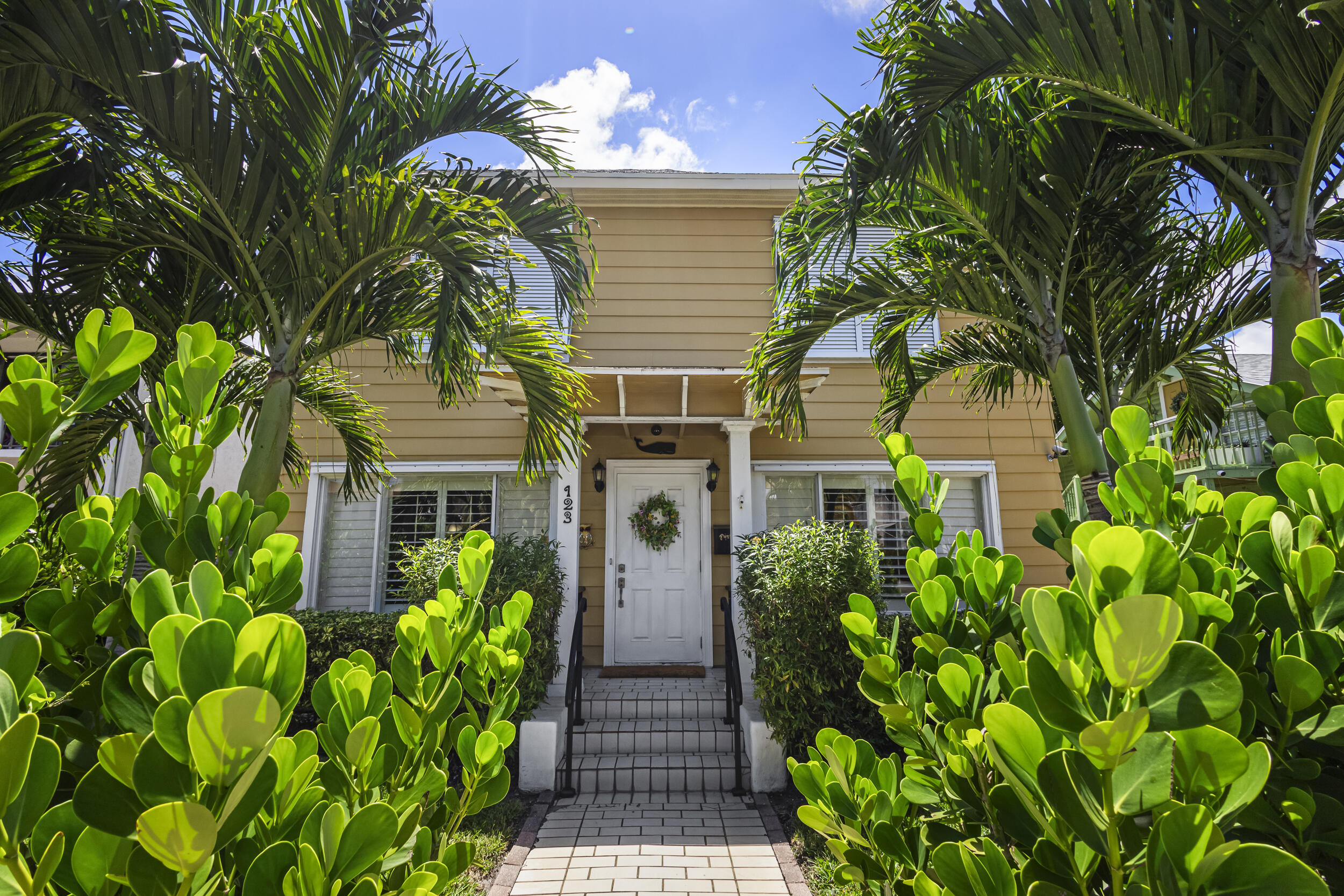 a front view of a house with a garden