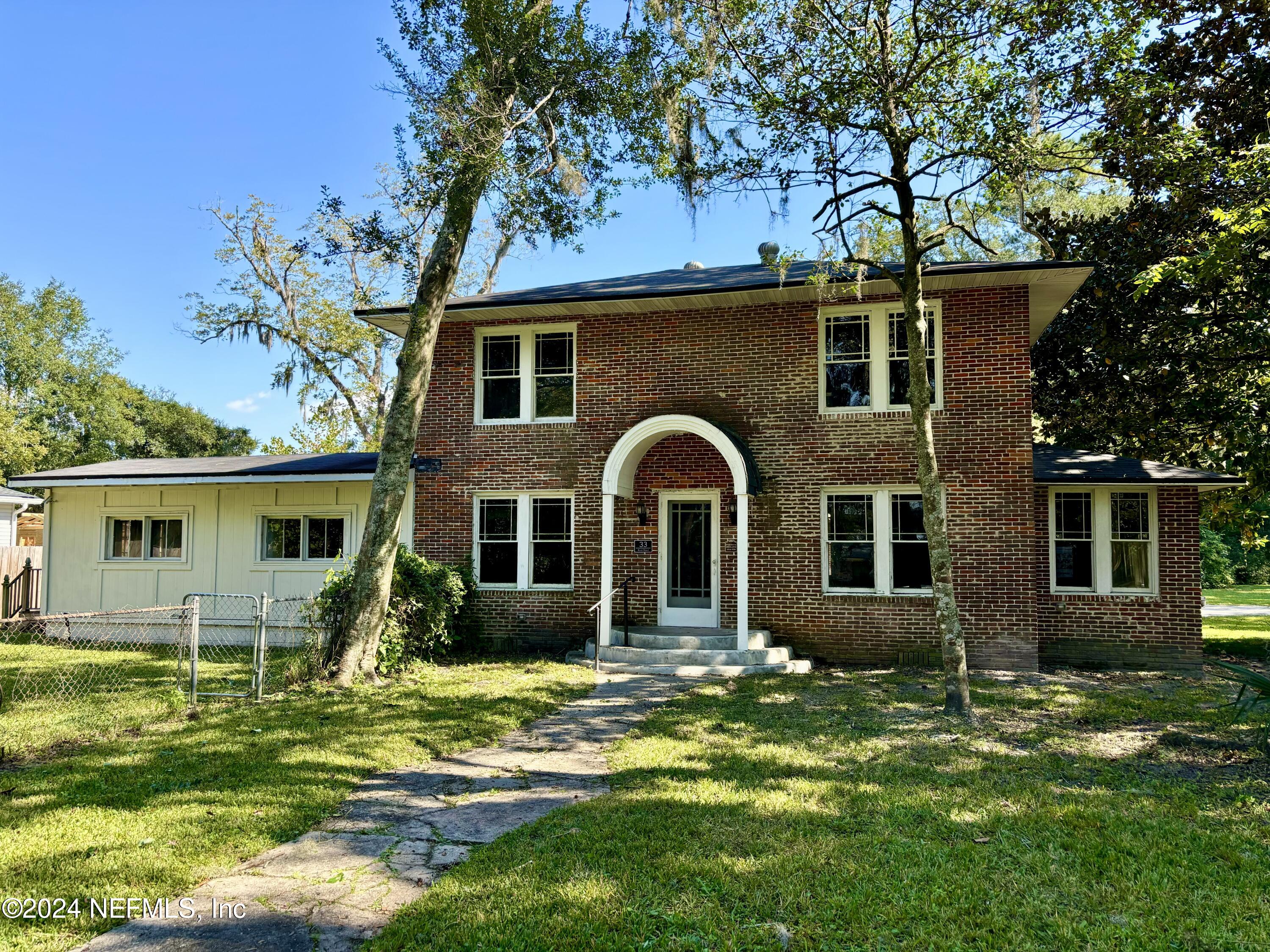 a front view of house with a garden