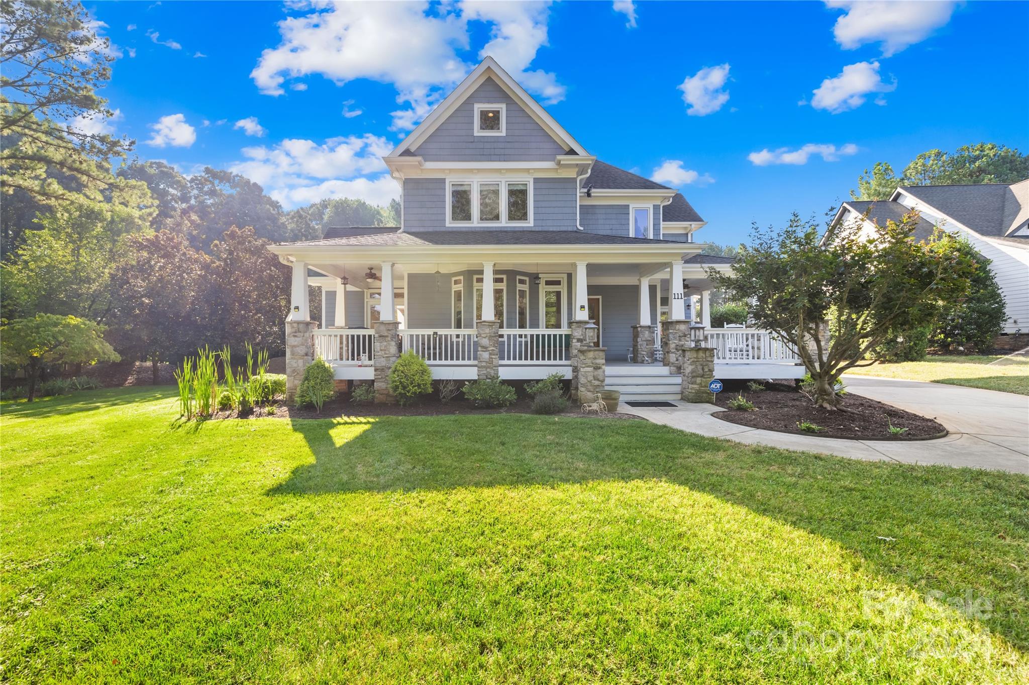 a front view of a house with swimming pool having outdoor seating