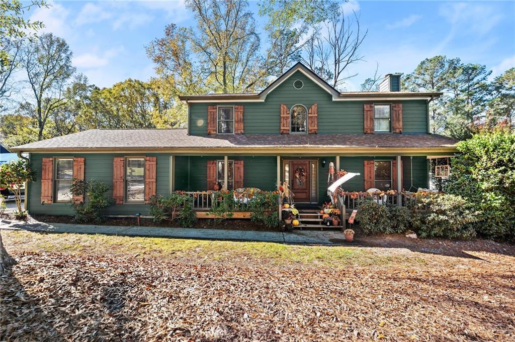 a front view of a house with yard and green space