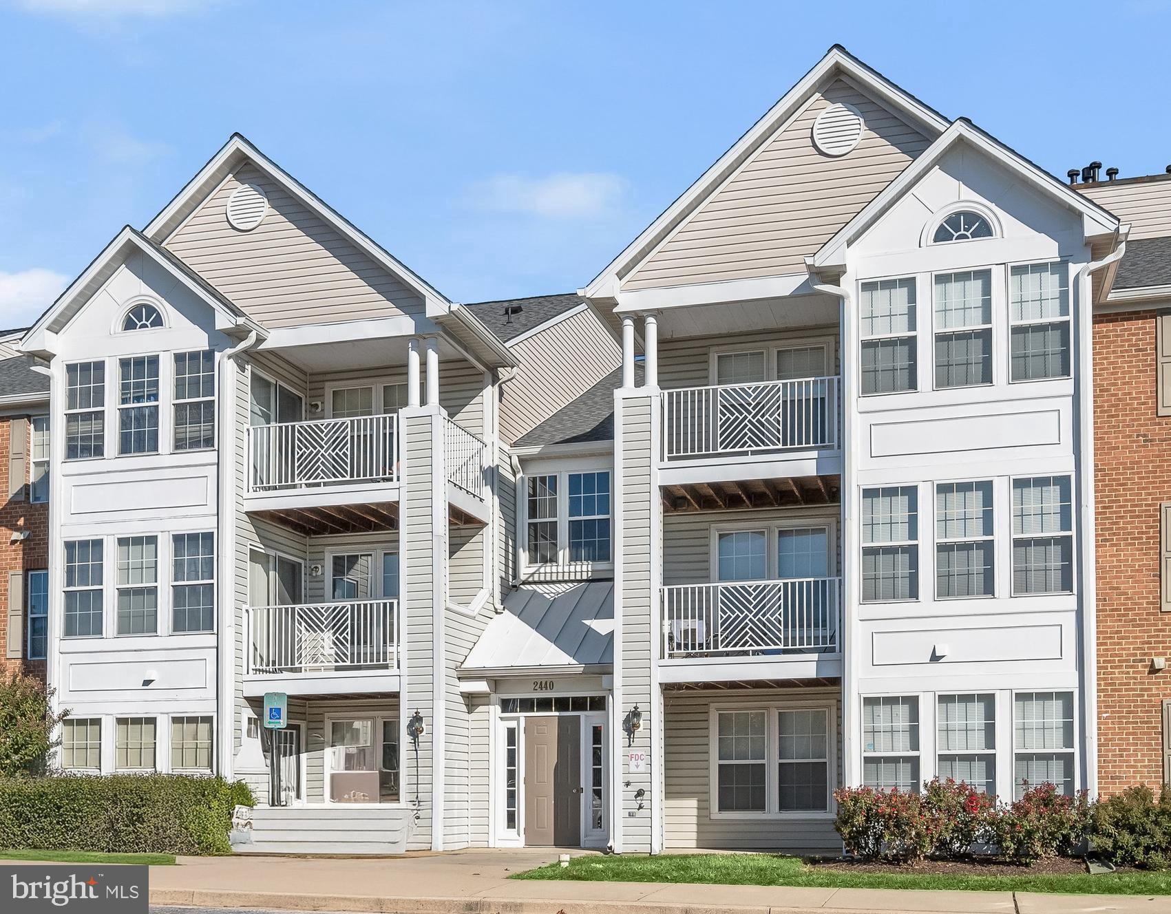 a front view of a residential apartment building with a yard