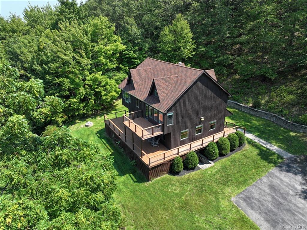 an aerial view of a house with a yard table and chairs