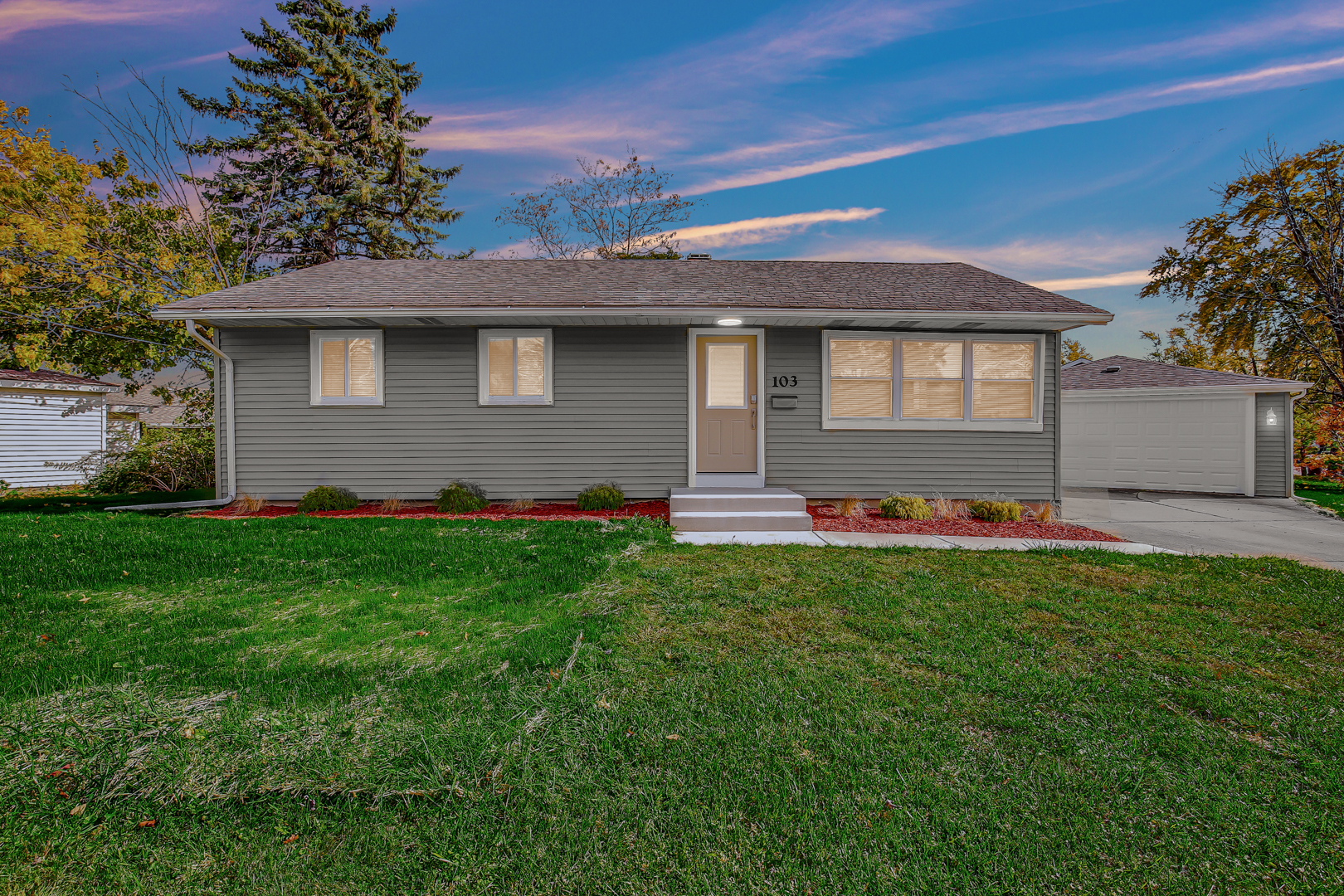 a front view of house with yard and green space