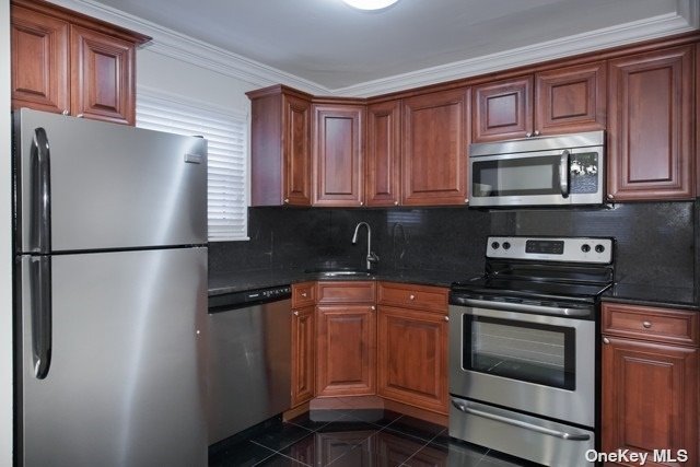 a kitchen with granite countertop a refrigerator stove and microwave