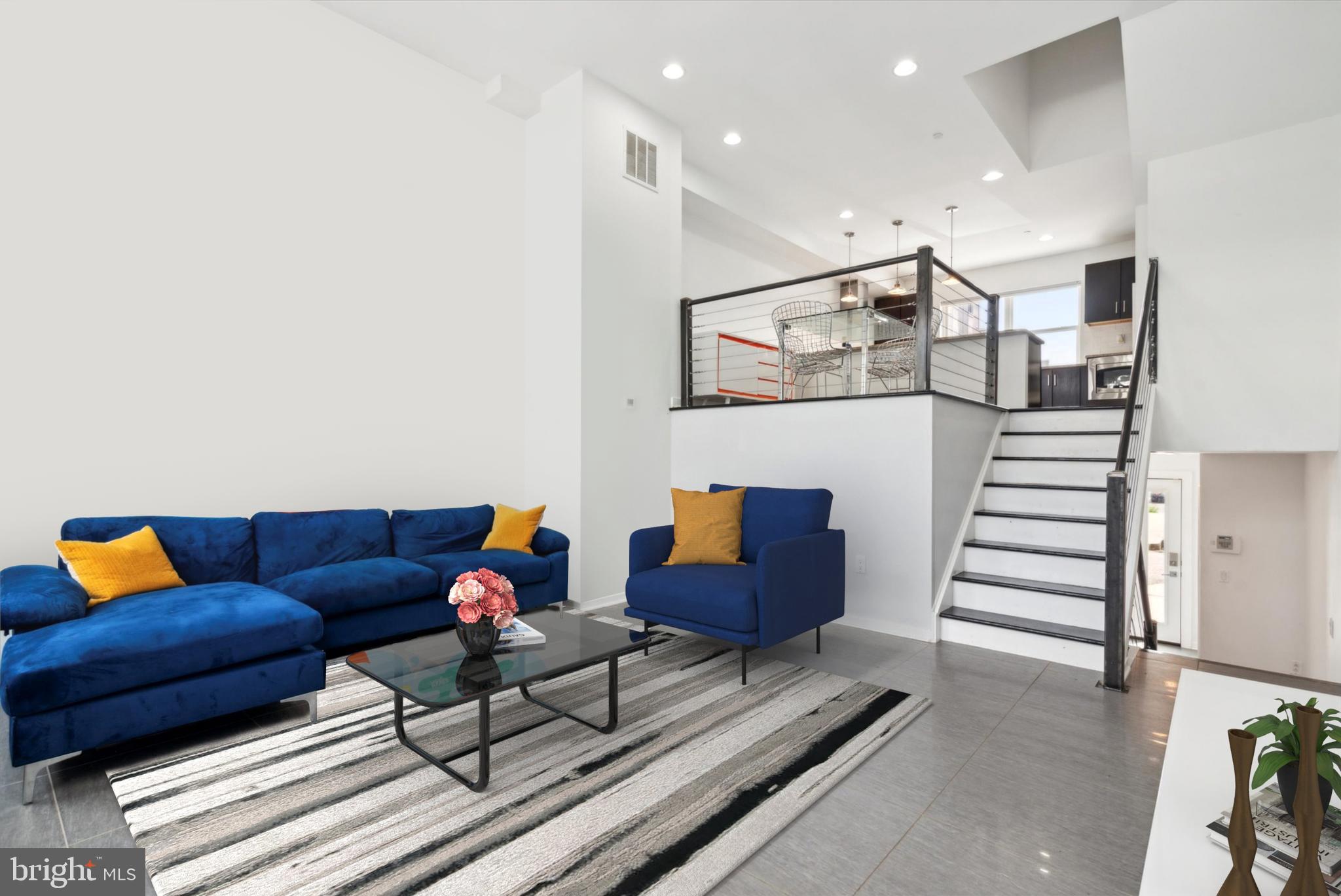 a living room with furniture and stairs