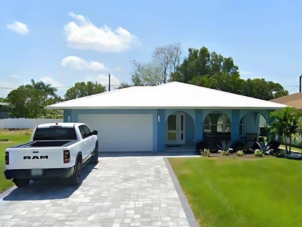 a front view of house with yard and outdoor seating