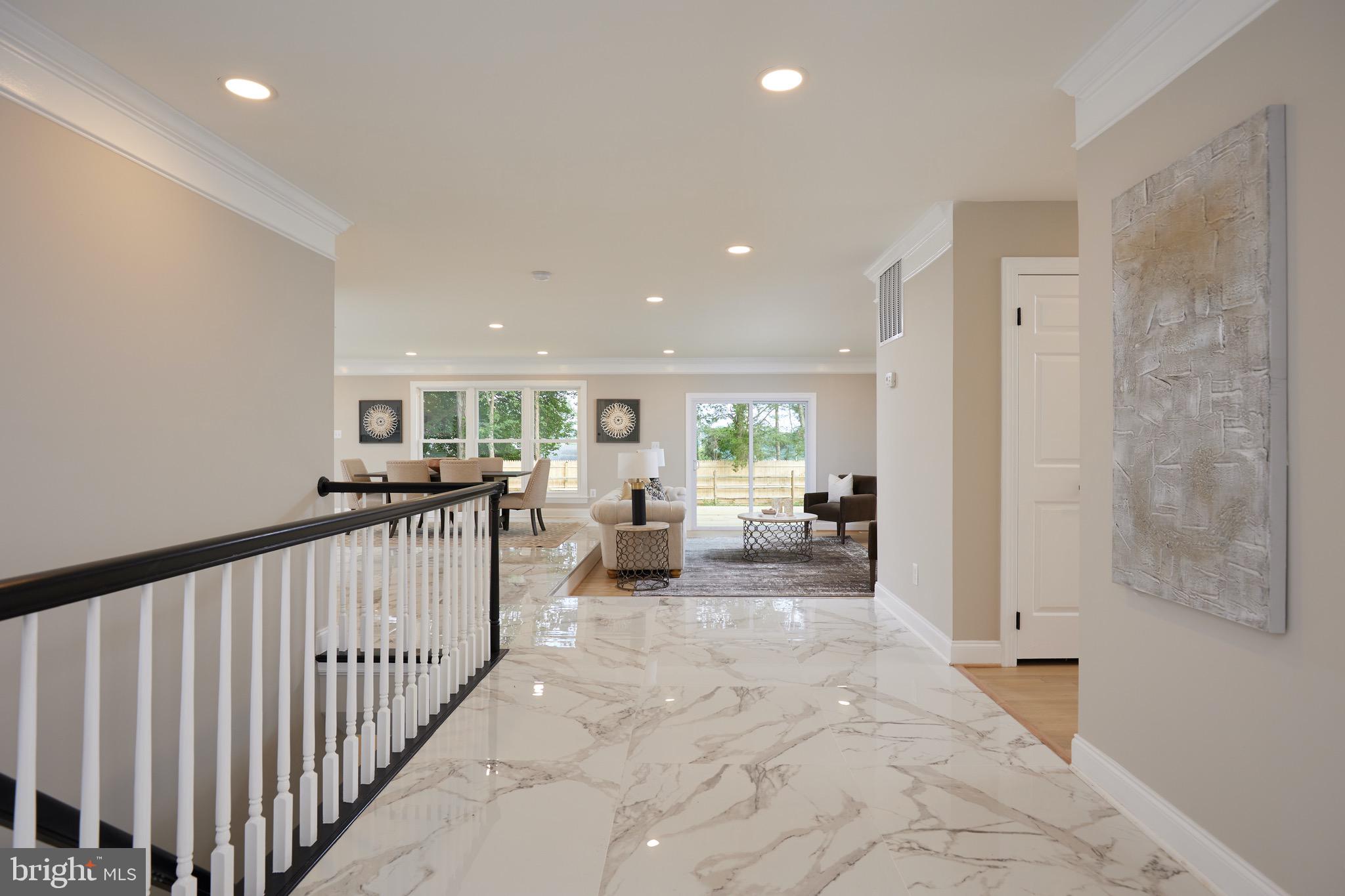 a view of a hallway with livingroom and furniture