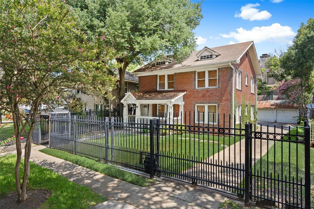 a view of a house with a small yard and a garden